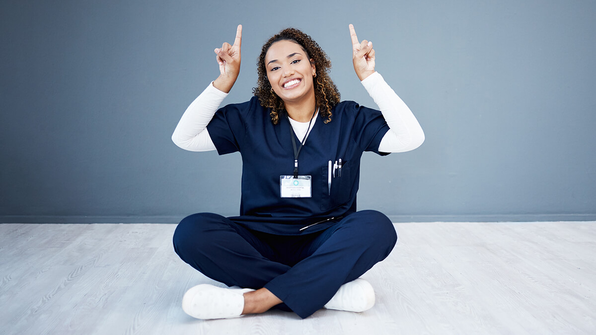 a healthcare worker pointing up with two fingers.