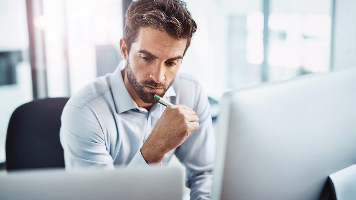 Business man thinking in front of computer